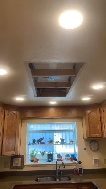 Before: a large rectangular opening cut into the textured kitchen ceiling