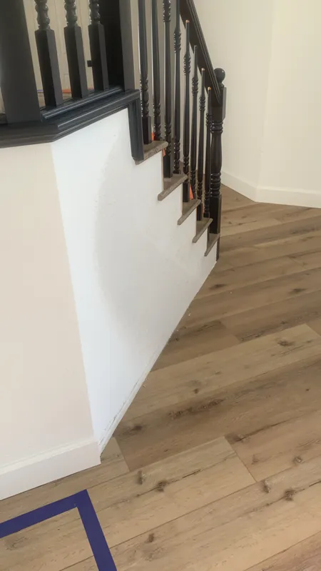 After: smooth, finished stairwell wall beside new wood floors