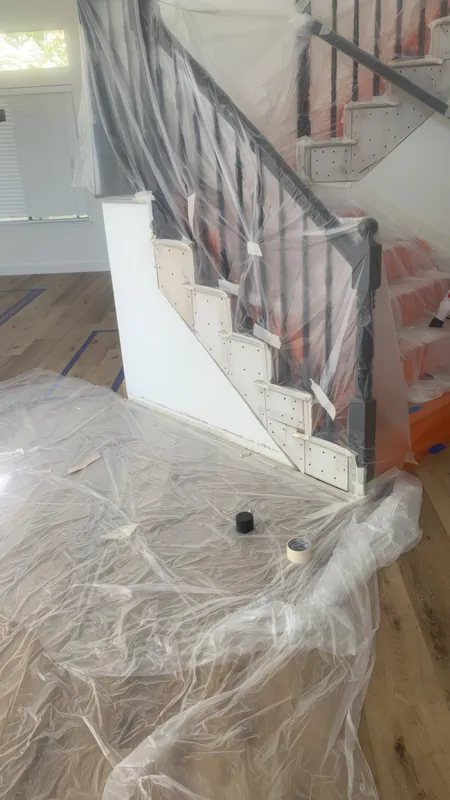 Before: stairwell wall masked in plastic during the repair